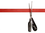 a pair of scissors cutting red tape